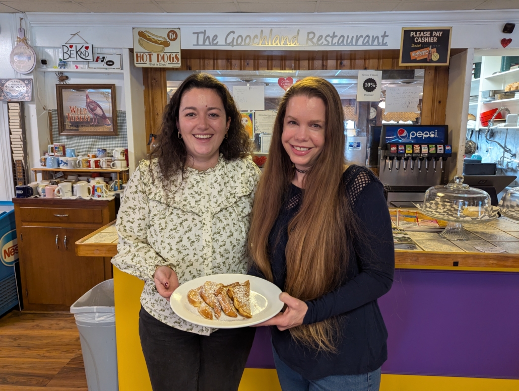 Clemence Nayral and Christine Fauver hold a plate of french toast in the goochland restaurant made from imported french bread