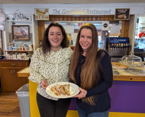 Clemence Nayral and Christine Fauver hold a plate of french toast in the goochland restaurant made from imported french bread